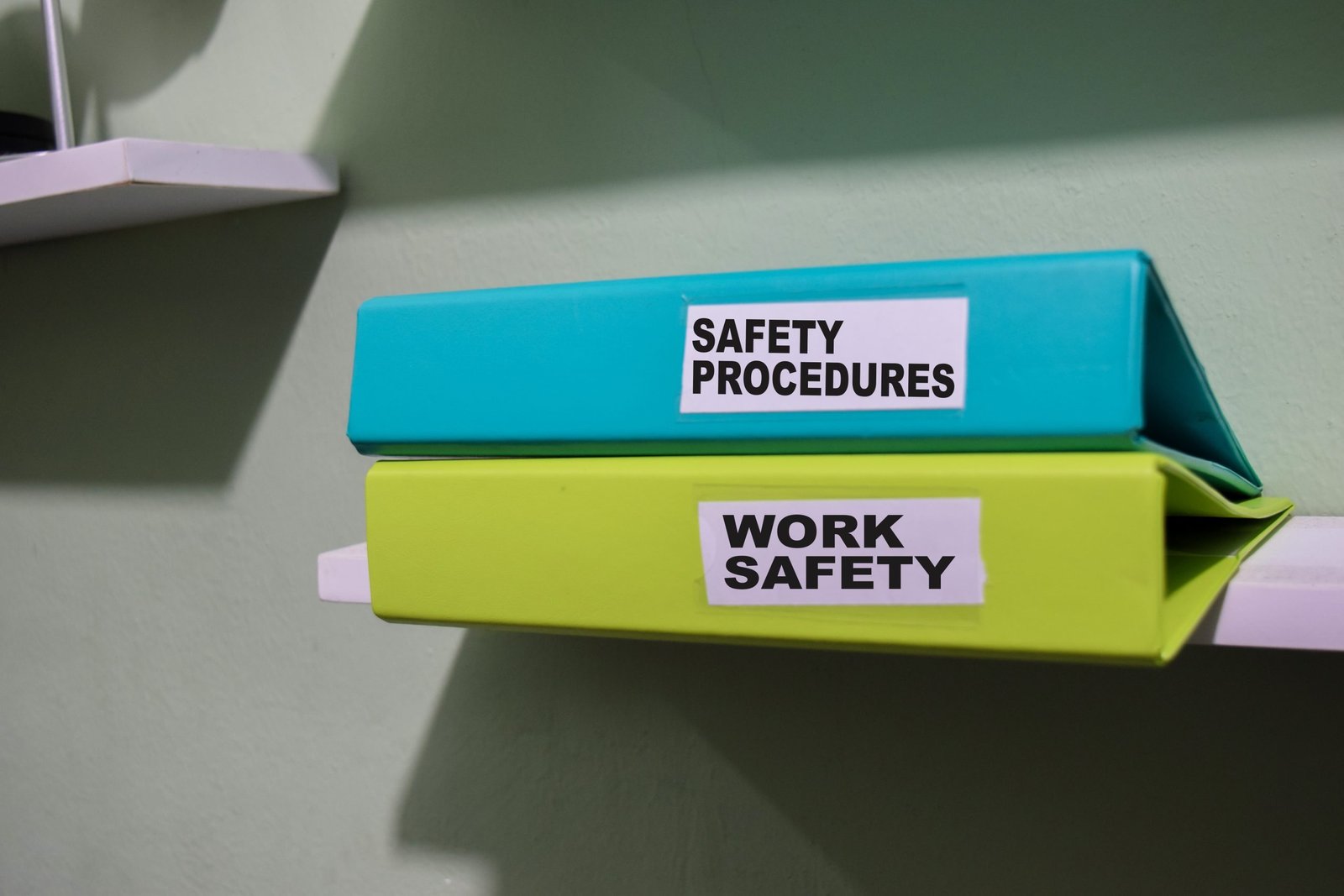 Folders,With,The,Label,Safety,Procedures,And,Work,Safety,,Business Organised safety folders labeled for WHS compliance and OHS manual storage.